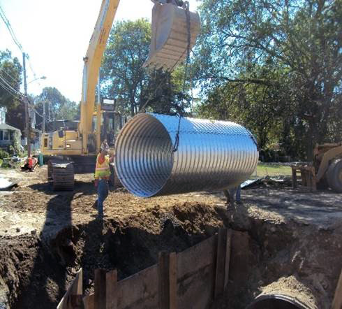 Installing 8-foot drain clulvert at Royal and Oak Streets